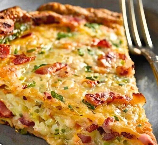 Delicious Bacon Potato Frittata served on a plate with herbs