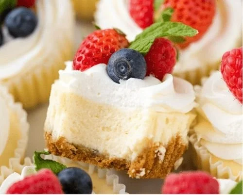 Delicious mini cheesecakes topped with fruits and whipped cream