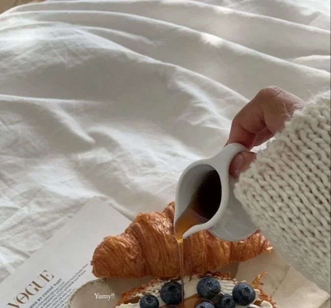 Croissant filled with fresh blueberries on a white plate