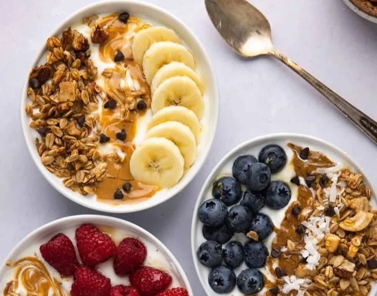 Yogurt granola bowls topped with fresh fruits and nuts