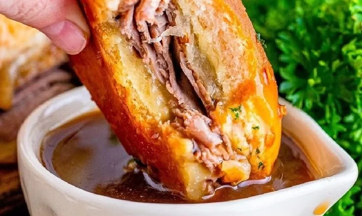 Delicious French Dip Sliders with juicy beef, cheese, and au jus for dipping