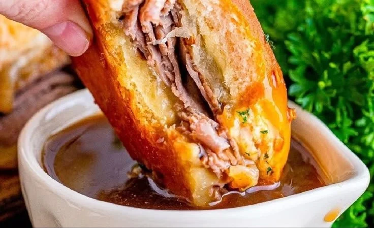 A plate of French Dip Sliders served with dipping au jus sauce.