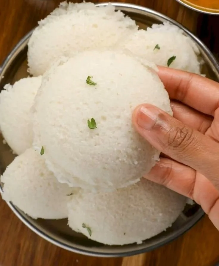 Delicious homemade poha idli served on a plate with chutney