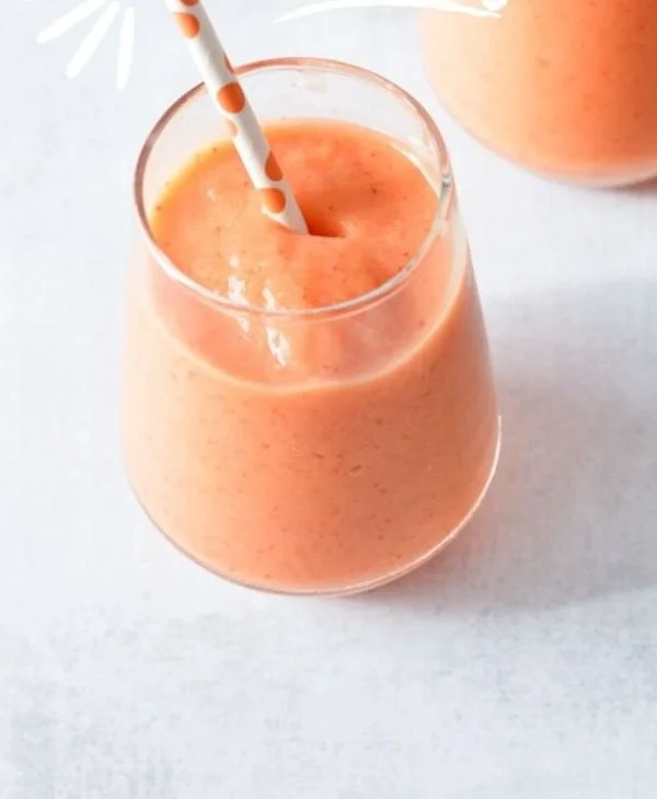 Refreshing strawberry pineapple smoothie in a glass with fresh fruits