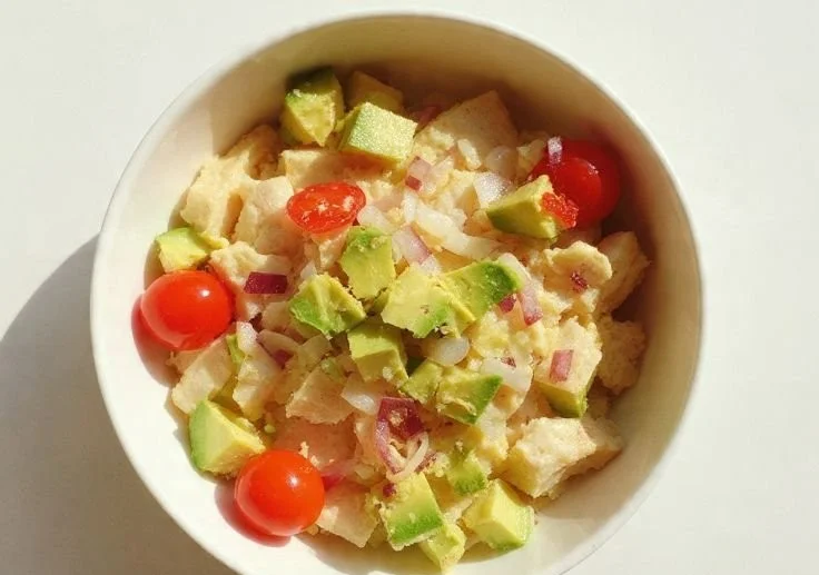 Avocado Chicken Salad served in a bowl with ingredients visibly mixed