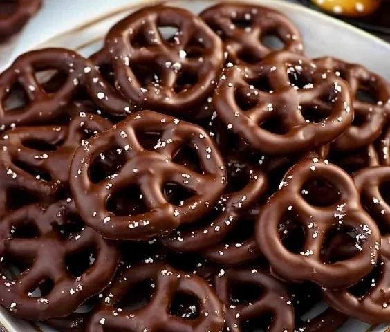 Delicious chocolate-dipped pretzels on a plate, ready to enjoy