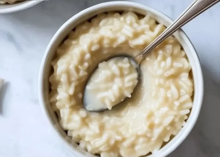 Dairy-free coconut milk rice pudding served in a bowl with a sprinkle of cinnamon