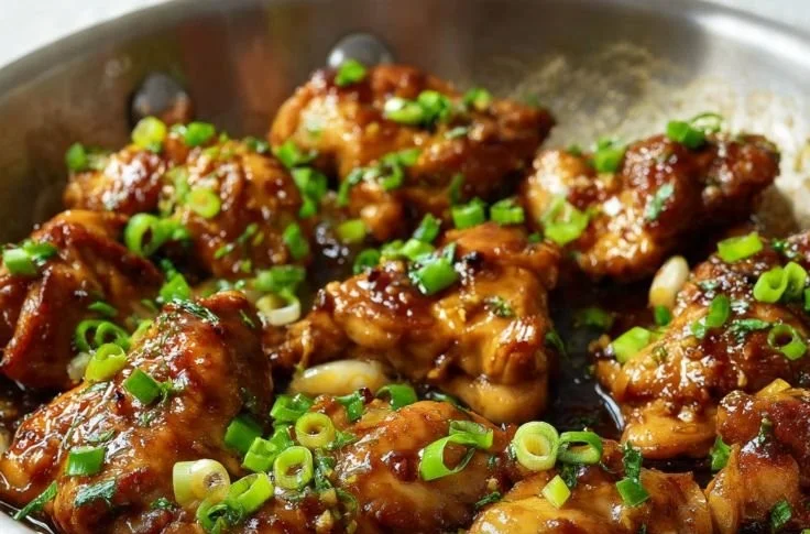 Delicious honey ginger chicken served on a plate with fresh herbs