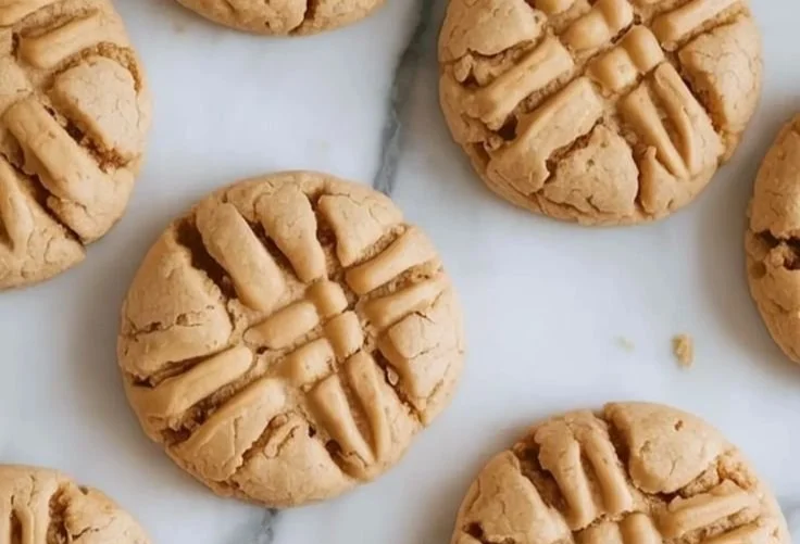 Freshly baked oat flour cookies on a cooling rack