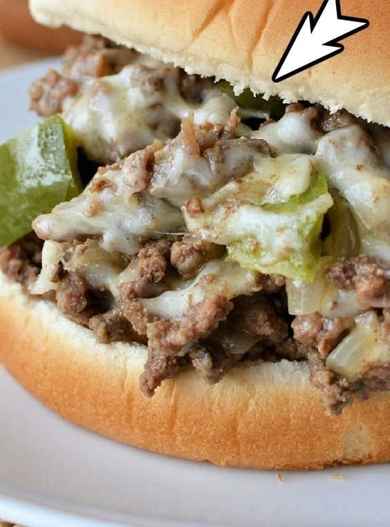 Delicious Sloppy Joe Philly cheesesteak sandwich showcasing melted cheese and savory beef.