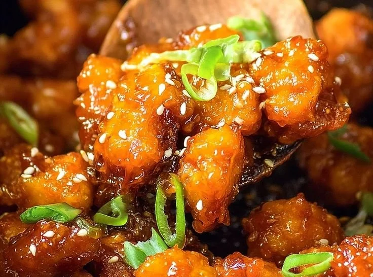 Asian Crockpot Orange Chicken served in a bowl with rice and vegetables