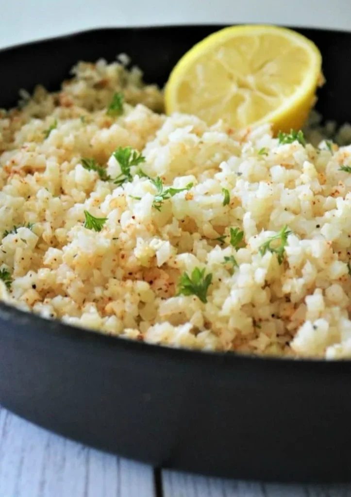 Delicious Garlic Butter Cauliflower Rice garnished with fresh herbs