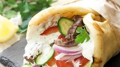 Delicious grilled skirt steak gyros served with fresh toppings and pita bread