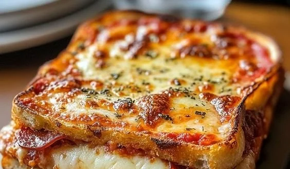 Delicious Pizza Grilled Cheese with melted cheese and pizza toppings
