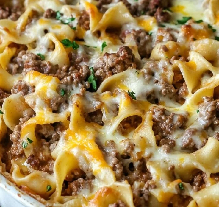 Sour Cream Beef Noodle Casserole served in a baking dish with cheese on top