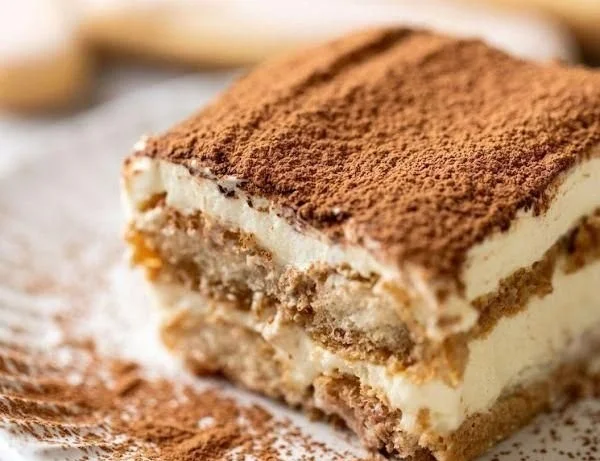 Delicious homemade tiramisu layered with coffee, mascarpone, and cocoa powder.