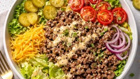 Big Mac style healthy burger bowl with fresh vegetables and toppings