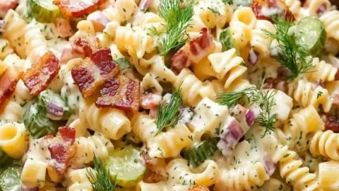 Delicious Dill Pickle Bacon Pasta Salad served in a bowl with fresh ingredients.