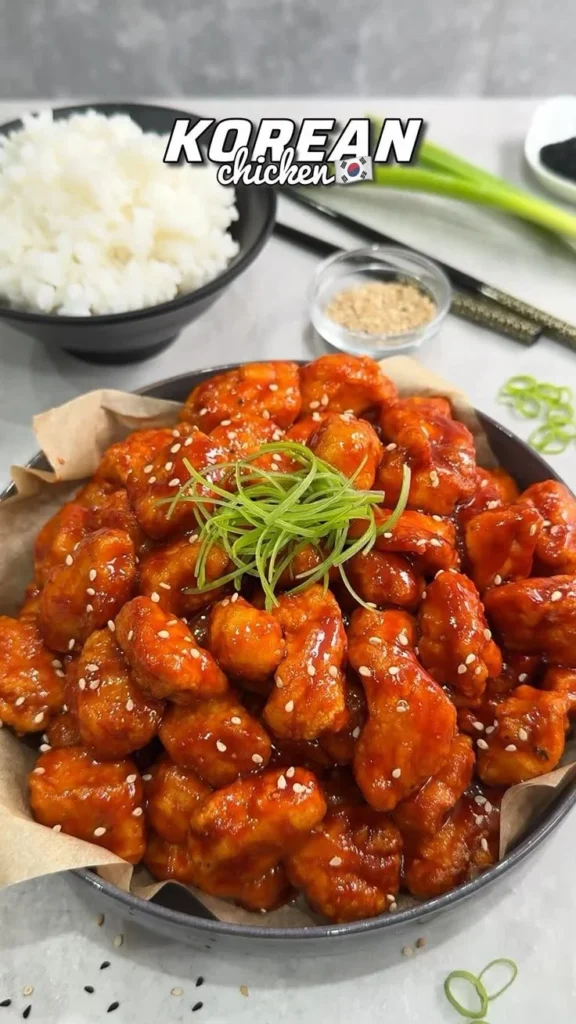 Healthy Korean Fried Chicken served with dipping sauce and fresh vegetables.