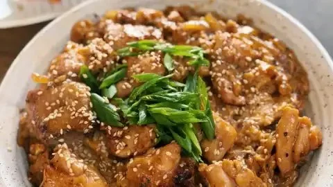 Japanese chicken and egg rice bowl served with fresh ingredients and flavors.