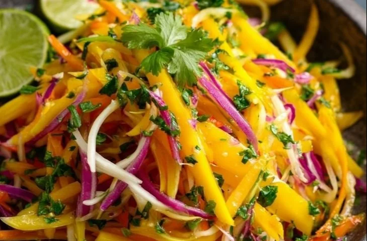 Bowl of colorful Mango Slaw made with fresh mango, vegetables, and dressing
