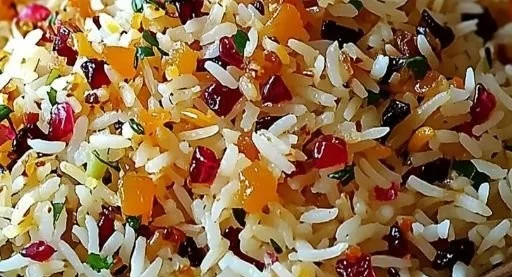 Dish of Persian Jeweled Rice garnished with nuts and dried fruits