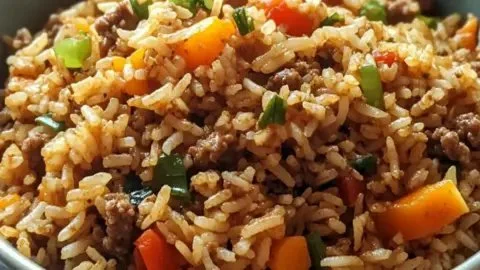 Plate of quick dirty rice with ground beef, garnished with herbs