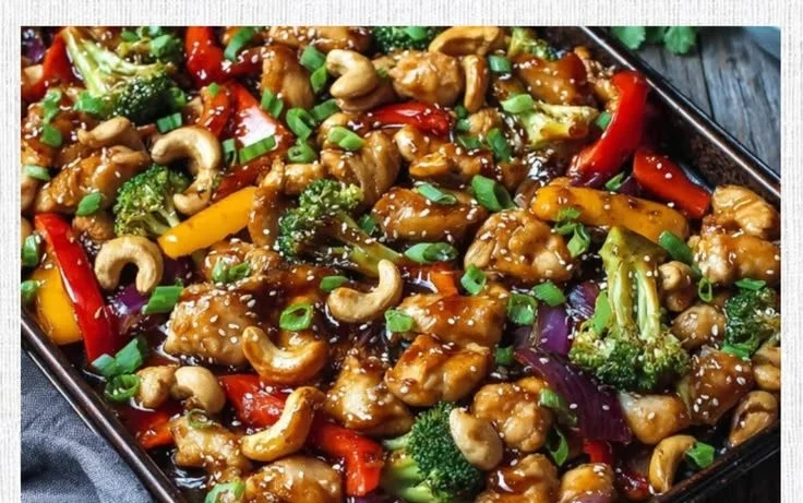 Sheet pan cashew chicken with colorful vegetables ready to serve.