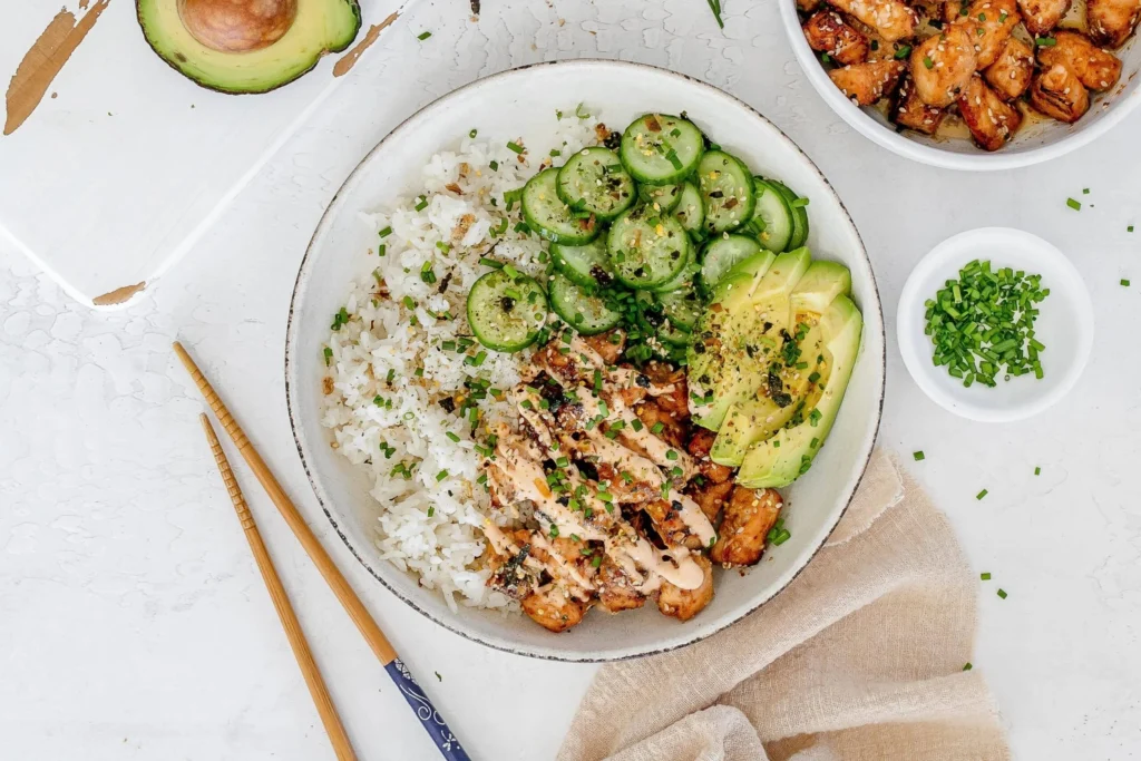 Spicy salmon bowls served with creamy coconut rice for a delicious meal