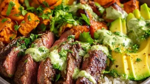 Steak and Sweet Potato Bowls topped with avocado and cilantro dressing