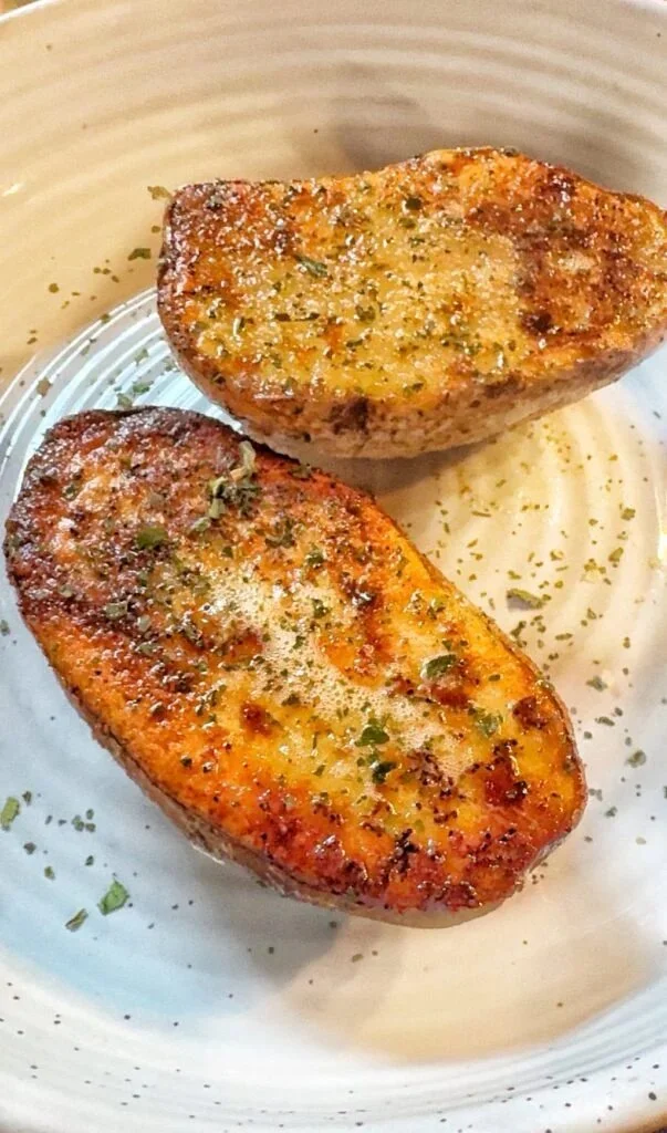 Delicious weeknight baked potatoes topped with sour cream, cheese, and chives.