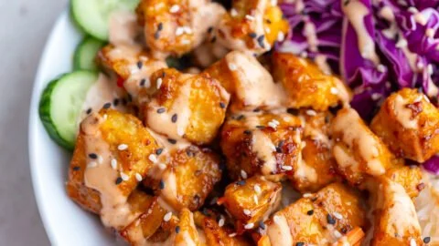 Crispy Bang Bang Tofu served with dipping sauce in a bowl