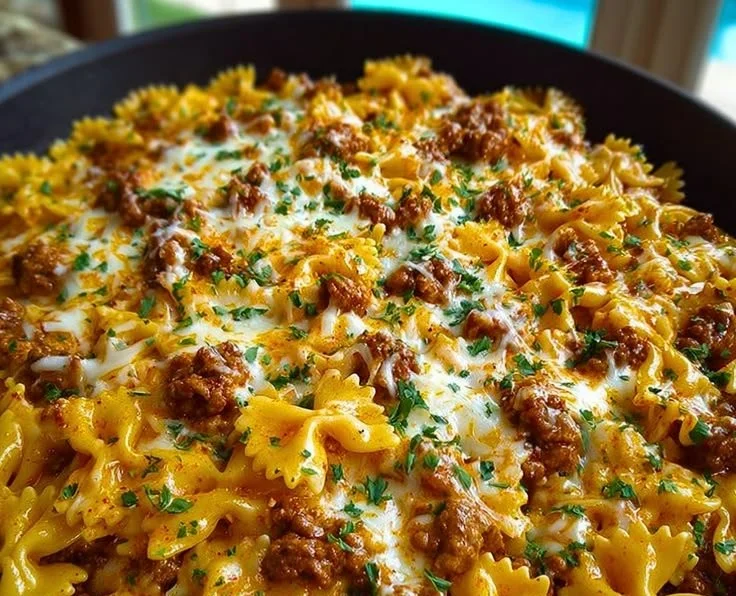 Cajun Cream Cheese Alfredo Bowties with Spiced Ground Beef served in a bowl.