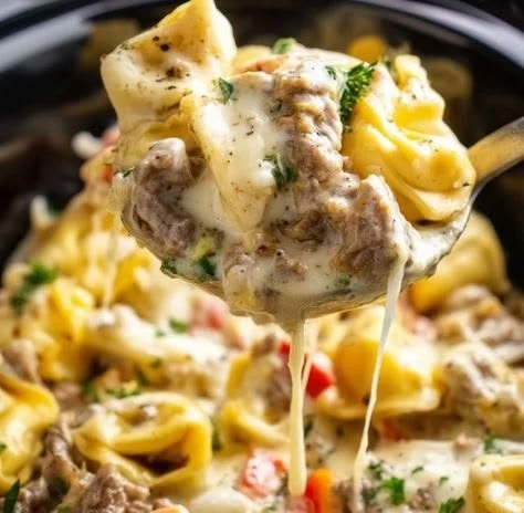 Crock Pot Cheesesteak Tortellini served in a bowl with fresh herbs