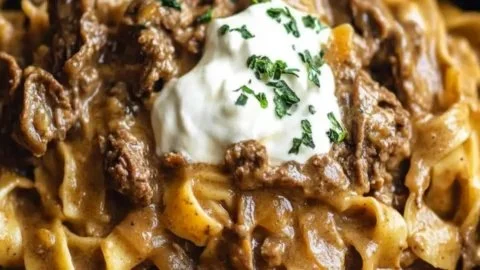 Crock Pot French Onion Beef and Noodles served in a cozy dining setting.
