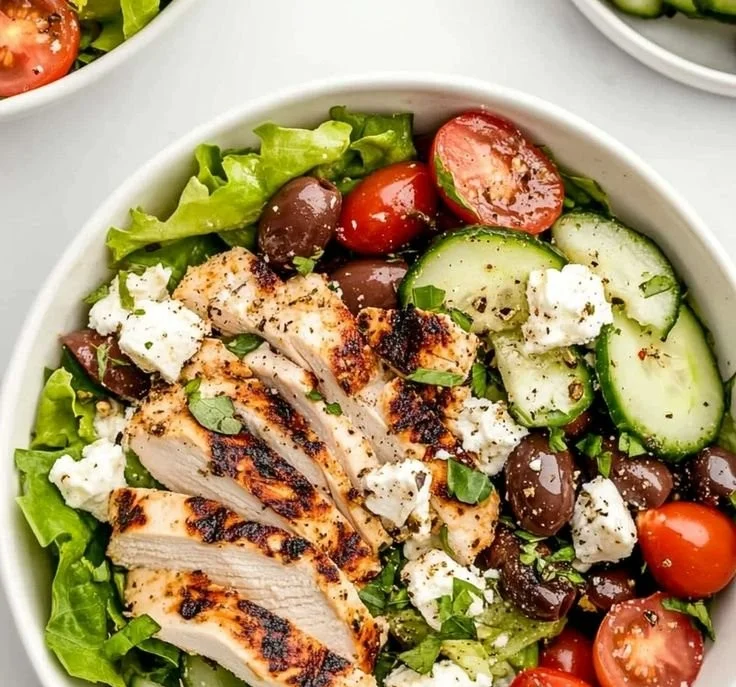 Fresh Greek salad with chicken, tomatoes, cucumbers, olives, and feta cheese
