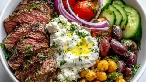 Delicious Mediterranean Steak Bowl with marinated steak and fresh vegetables