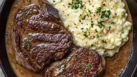 Savory Gaelic Irish Steaks with whiskey cream sauce and colcannon on a plate.