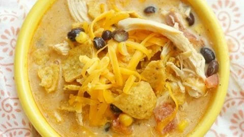 Delicious slow cooker cheesy chicken chili topped with cheese and cilantro