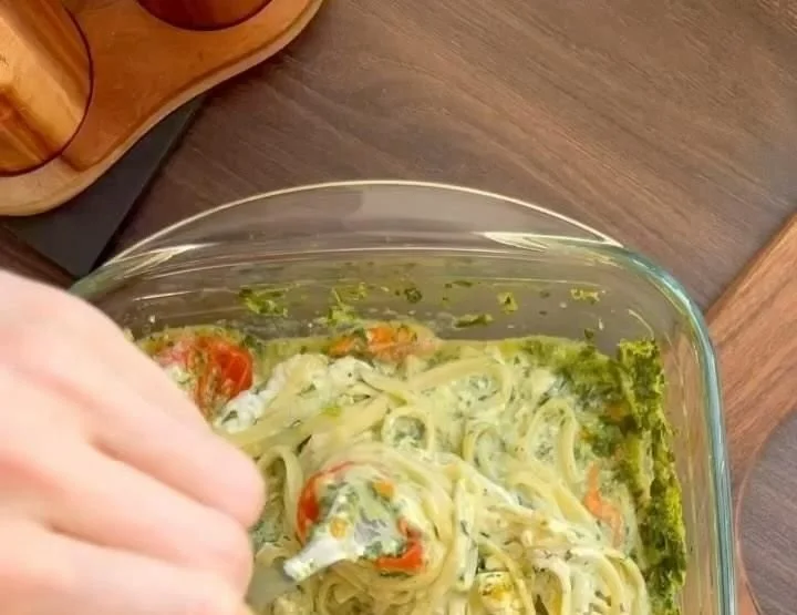 Freshly made spinach pasta dish with vibrant greens and toppings.