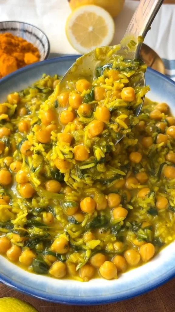 Bowl of turmeric rice with chickpeas and spinach, a colorful and healthy dish