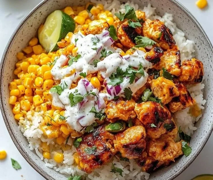Vibrant chicken and corn rice bowl garnished with fresh herbs