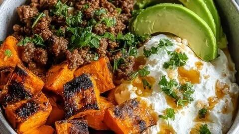 Delicious beef hot honey bowl topped with fresh ingredients and honey drizzle.