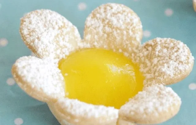 Mini lemon flower tarts garnished with edible flowers